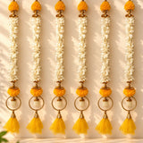 Bangle pom pom hanging backdrop garland with golden ornamental design, white jasmine flowers, and orange pom-poms for festive decor