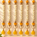 Bangle pom pom hanging backdrop garland with golden ornamental design, white jasmine flowers, and orange pom-poms for festive decor