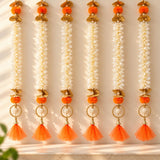 Bangle pom pom hanging backdrop garland with white jasmine flowers orange pom-poms gold accents and tassels for festive décor