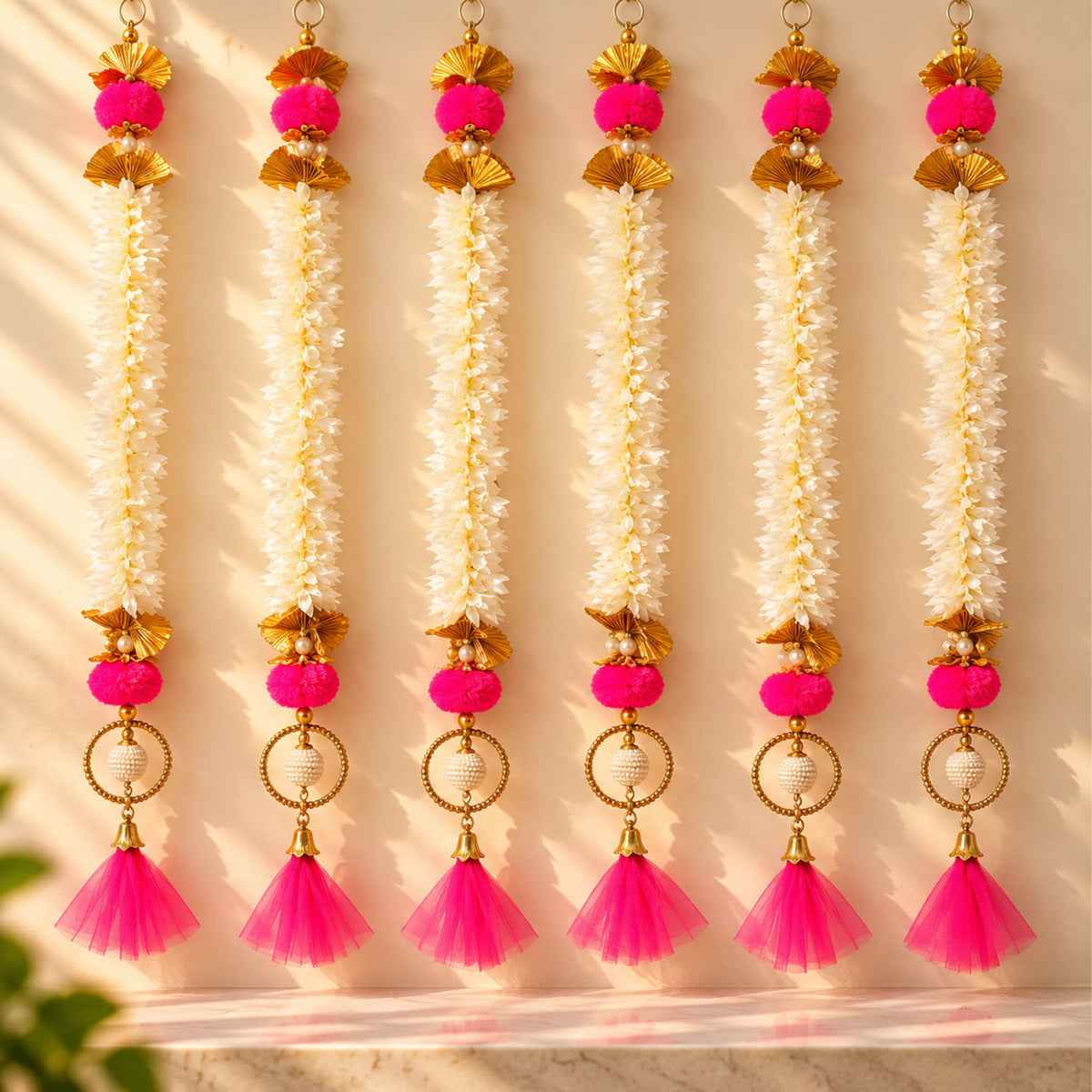 Bangle pom pom hanging backdrop garland with bright pink and gold tassels pom-poms white floral strands for festive decor