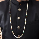 Handmade Barati Swagat Mala pearl necklace with red green accents on black shirt