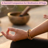 Gold and brown Rudraksha 5-mukhi bead bracelet on wrist