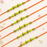 Five traditional golden ornamental designer bead rakhi bracelets with lime green beads on red and gold thread for protection and good luck