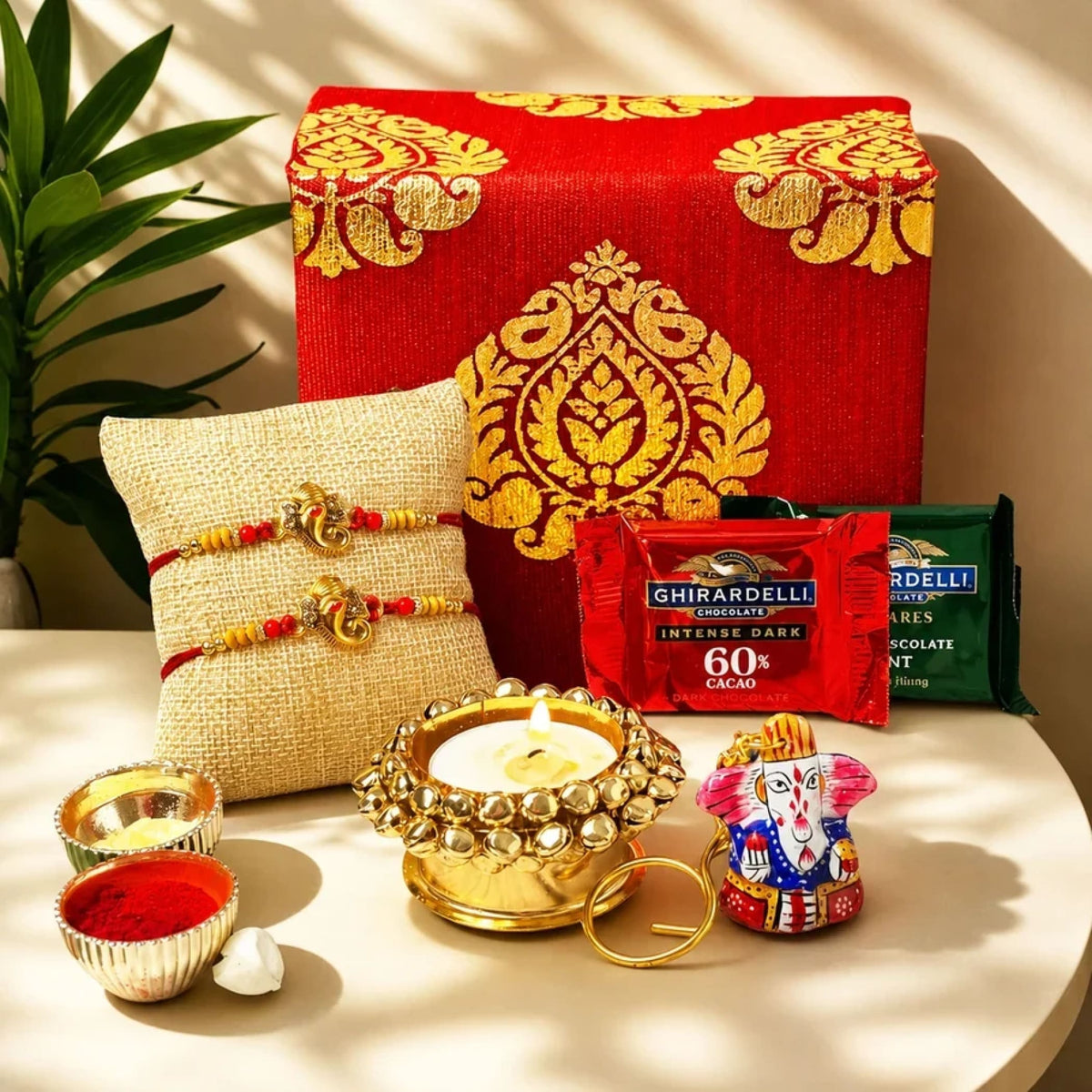 Red and gold patterned gift box with intricate golden embroidery in bhai dooj gift hamper for brother and bhabhi