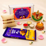 Purple and yellow cadbury dairy milk caramello chocolate bar with glossy wrapper in bhai dooj gift hamper for brother and bhabhi