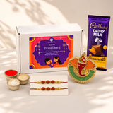 Gilded elephant-shaped decorative pin with red green and gold enamel in Bhai Dooj gift hamper for brother and bhabhi