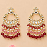Elegant gold tone oversized Indian kundan chandelier earrings with clear stones, pink and red beads, and white pearls