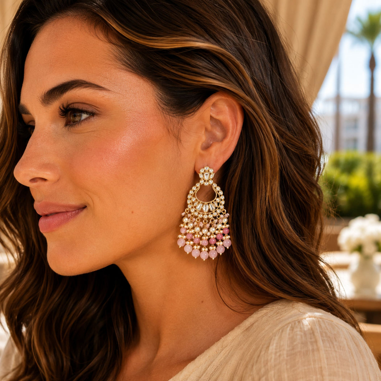 Delicate gold-toned oversized Indian kundan chandbali earrings with clear crystals and soft pink beads for diwali and weddings