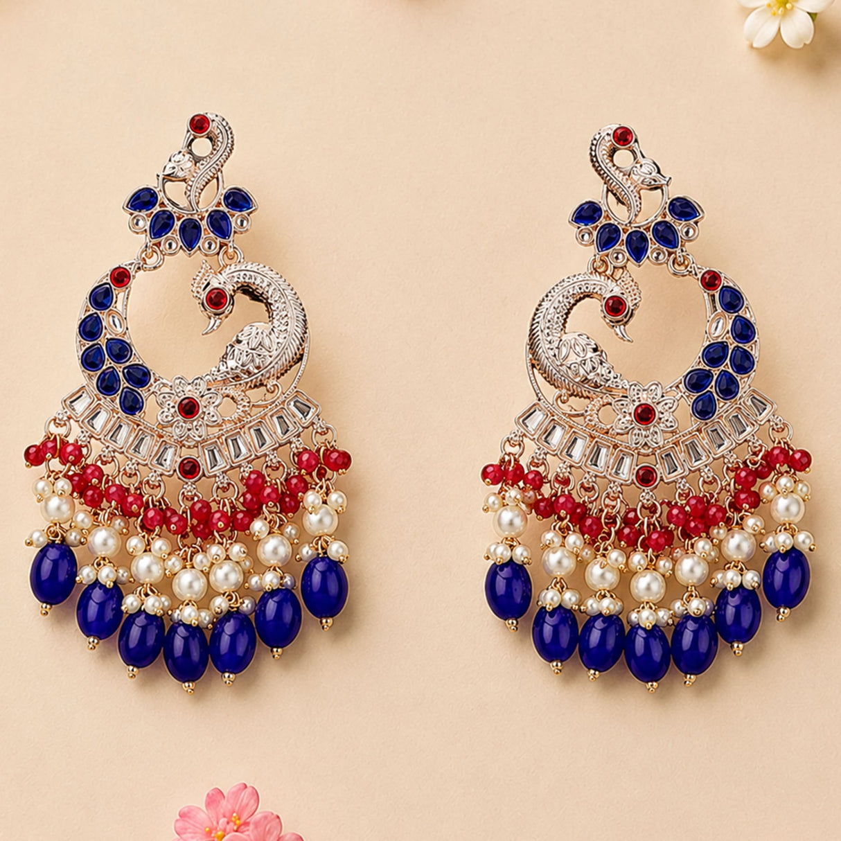 Elegant oversized Indian peacock kundan chandelier earrings with silver filigree, blue and red gemstones, pearls, and beads
