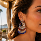 Silver peacock-shaped oversized Indian jhumka earring with blue red beads pearls and intricate metalwork for Diwali and weddings