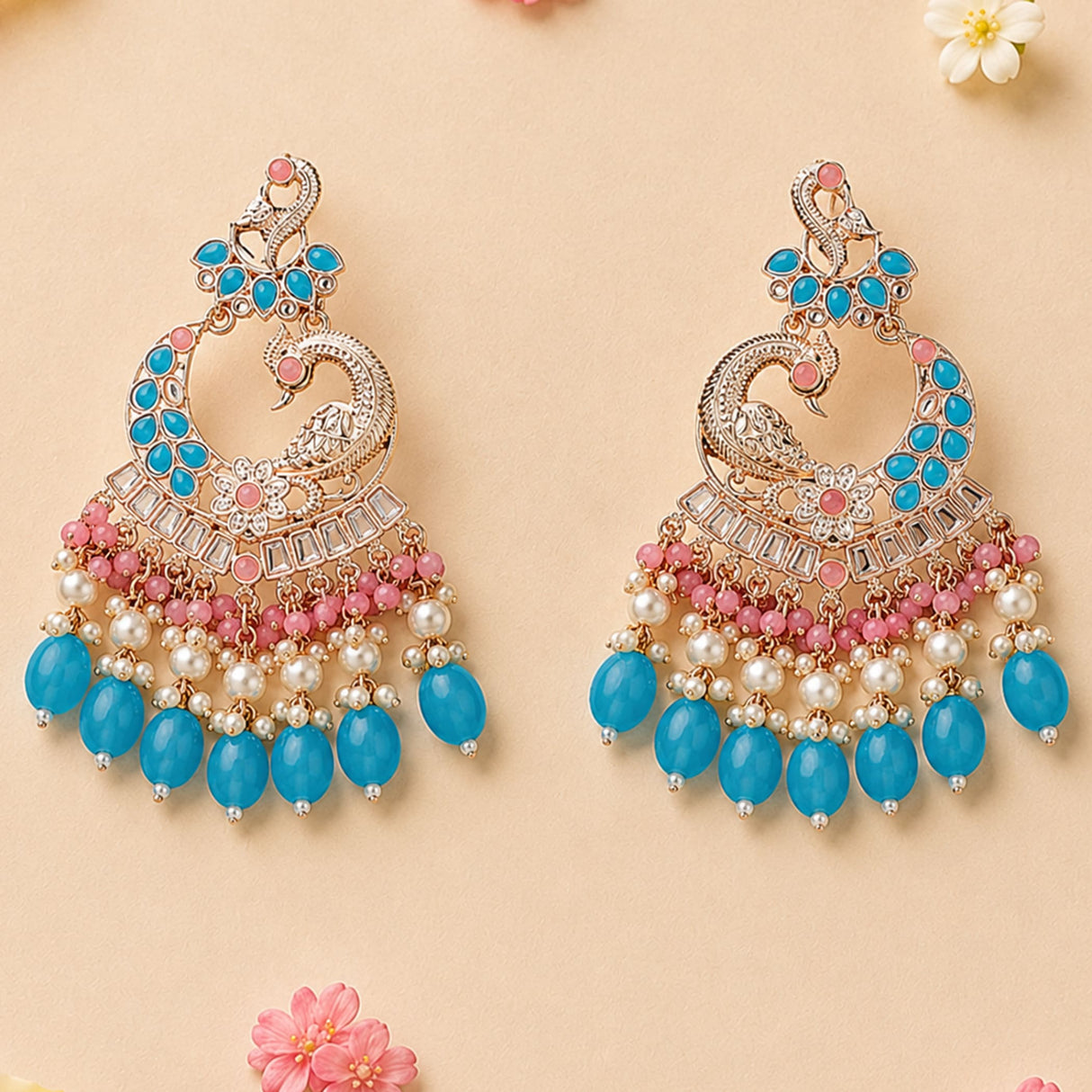 Elegant gold tone oversized Indian peacock kundan earrings with turquoise pink stones white pearls and blue beads for Diwali wedding