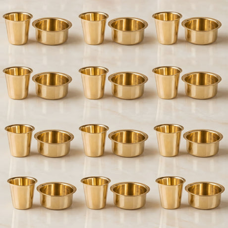 Golden brass candle holders arranged in neat rows for south indian brass coffee cup and dabara matte plain set