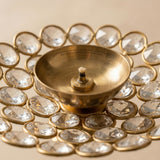 Golden brass decorative diya with central wick and clear crystal stones in gold bezels for diwali puja decor