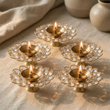 Four golden brass decorative diyas with delicate acrylic glass floral design for Diwali puja and home temple decor