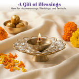 Brass decorative diya with crystal-encrusted lotus base and lit wick for Diwali puja and home temple decor