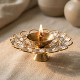 Brass decorative diya with golden finish and clear acrylic glass floral design for Diwali puja and home temple decor
