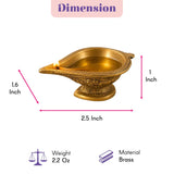 A golden brass diya with intricate engraved patterns and a small flame for traditional Hindu puja and Diwali decor