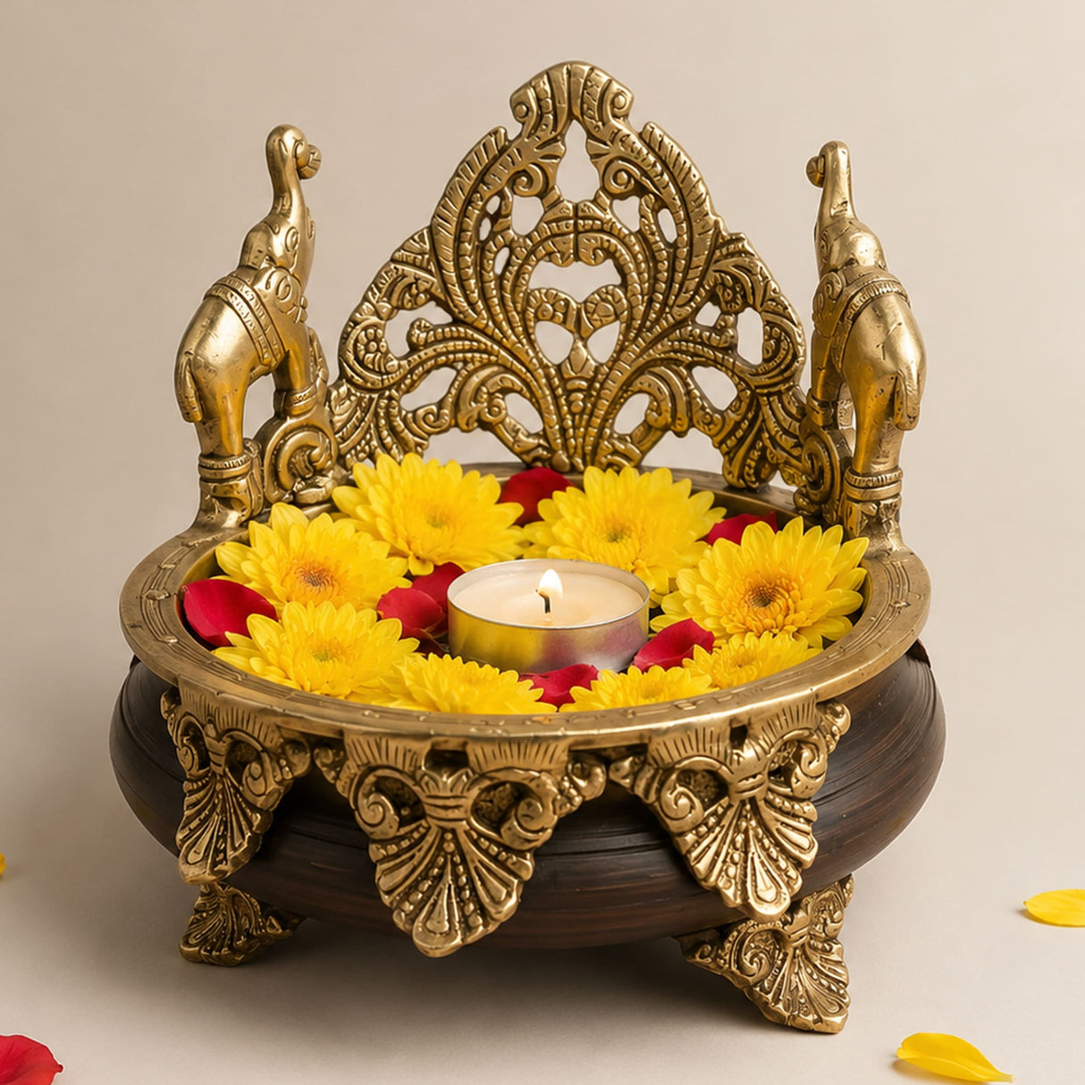 Golden brass elephant-themed decorative oil lamp holder with intricate filigree design and dark wooden base for ethnic decor