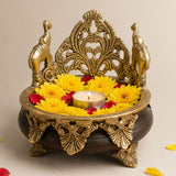 Golden brass elephant-themed decorative oil lamp holder with intricate filigree design and dark wooden base for ethnic decor