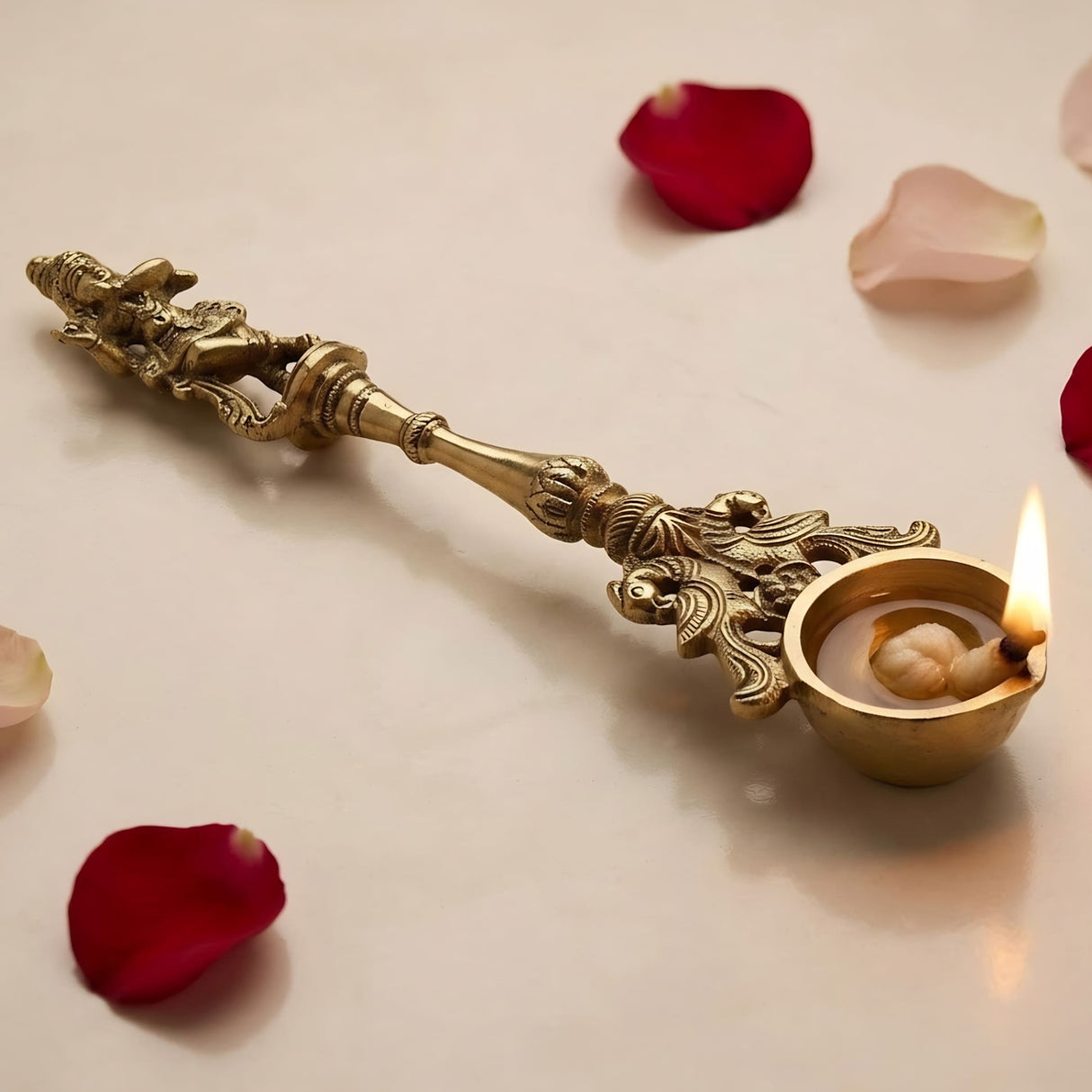 Decorative golden brass oil lamp with intricate carvings and lit flame for ganesha krishna religious decor