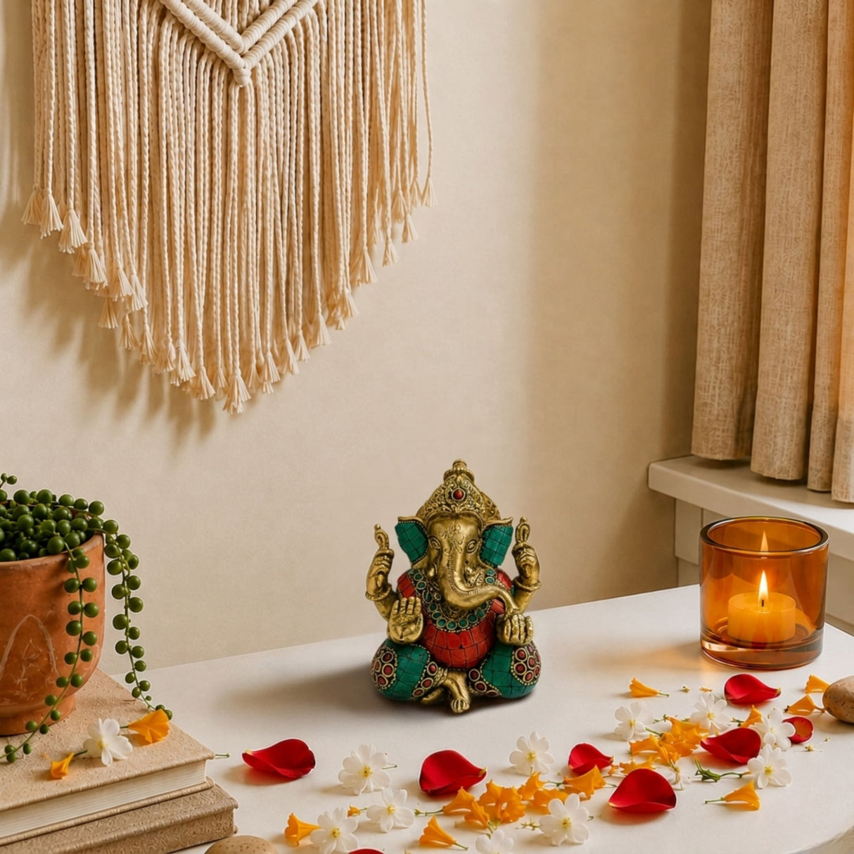 A golden and teal brass ganesha statue idol with intricate red and green detailing for pooja and home decor