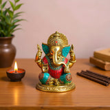 Golden Ganesha brass statue with turquoise red inlay, intricate elephant head arms