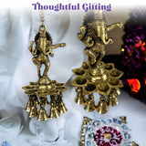 Golden brass ganesha wall hanging diya with intricate carvings and dangling bells for home temple and diwali decor