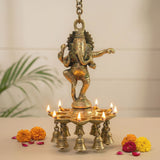 Golden brass ganesha wall hanging diya with intricate carvings and eight bells for home temple office decor