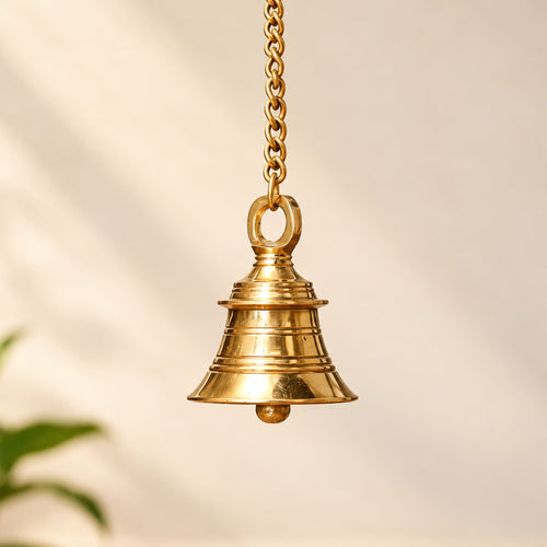 Brass hanging bell with chain featuring tiered ridges and a small ball for temple and spiritual decor use