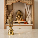 Golden brass Krishna bell featuring lord Krishna playing flute on a bell-shaped base for Indian pooja and decor
