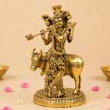 Golden brass lord krishna statue riding bull playing flute with ornate headgear for home temple decor diwali pooja gift