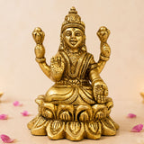 Golden brass lakshmi idol statue with four arms seated on lotus base for diwali puja home temple decor