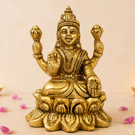 Golden brass lakshmi idol statue with four arms seated on lotus base for diwali puja home temple decor