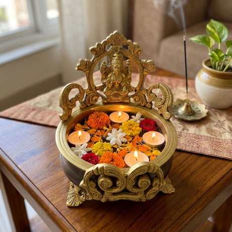 Brass Laxmi Urli Bowl with Ganesha carvings, floating candles, marigolds