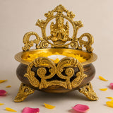 Golden ornate brass laxmi urli bowl 6.6 inch with intricate filigree and seated deity for home temple decor and pooja
