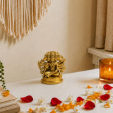 Golden brass panchmukhi hanuman statue with multiple heads and arms seated on an ornate circular base for pooja decor