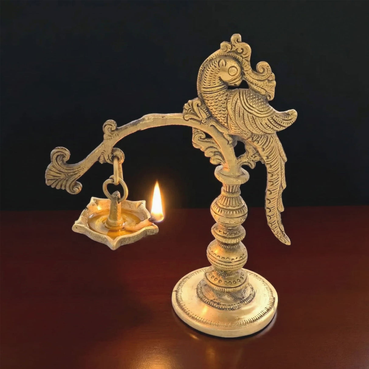 Golden brass annam oil lamp diya with intricate peacock design and ornate base for home temple and diwali decoration