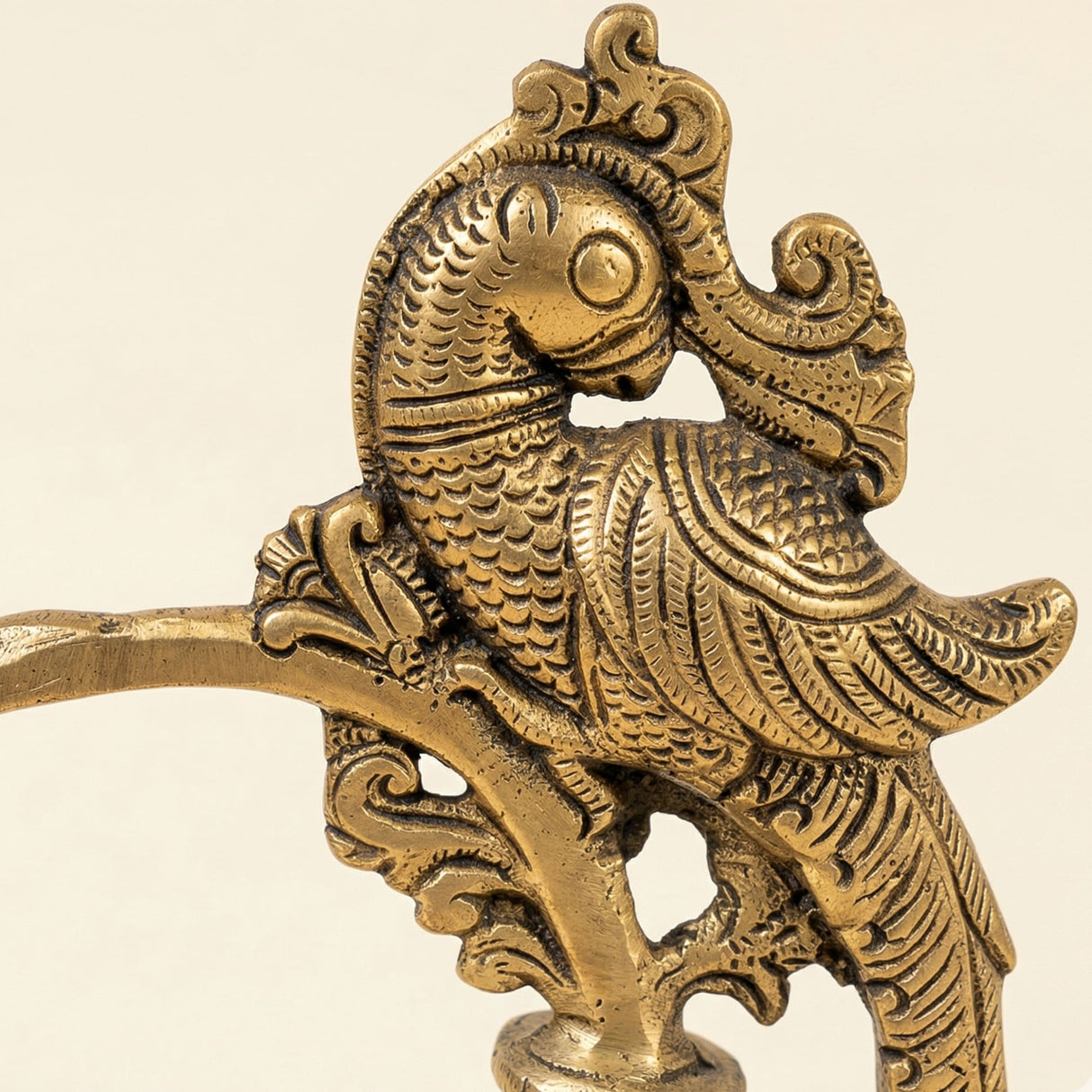 Golden brass ornamental bird figurine with intricate feather and scrollwork detailing for traditional kerala lamp decor