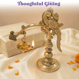 Golden brass bird-shaped annam oil lamp diya with intricate carvings and lit flame for home temple diwali decoration