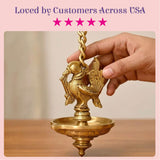 Golden brass bird-shaped hanging oil lamp diya with intricate feather and beak detailing for temple and diwali decor