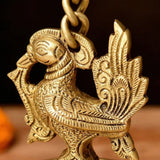 Golden brass peacock wall hanging diya with intricate engravings and chain loop for home temple diwali decor and puja use