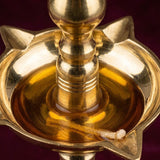 Golden brass oil lamp diya with star-shaped base and central wick holder for home temple mandir and diwali decoration