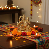 Golden Hindu deity statue with intricate details and vibrant marigold flowers for Pooja decor