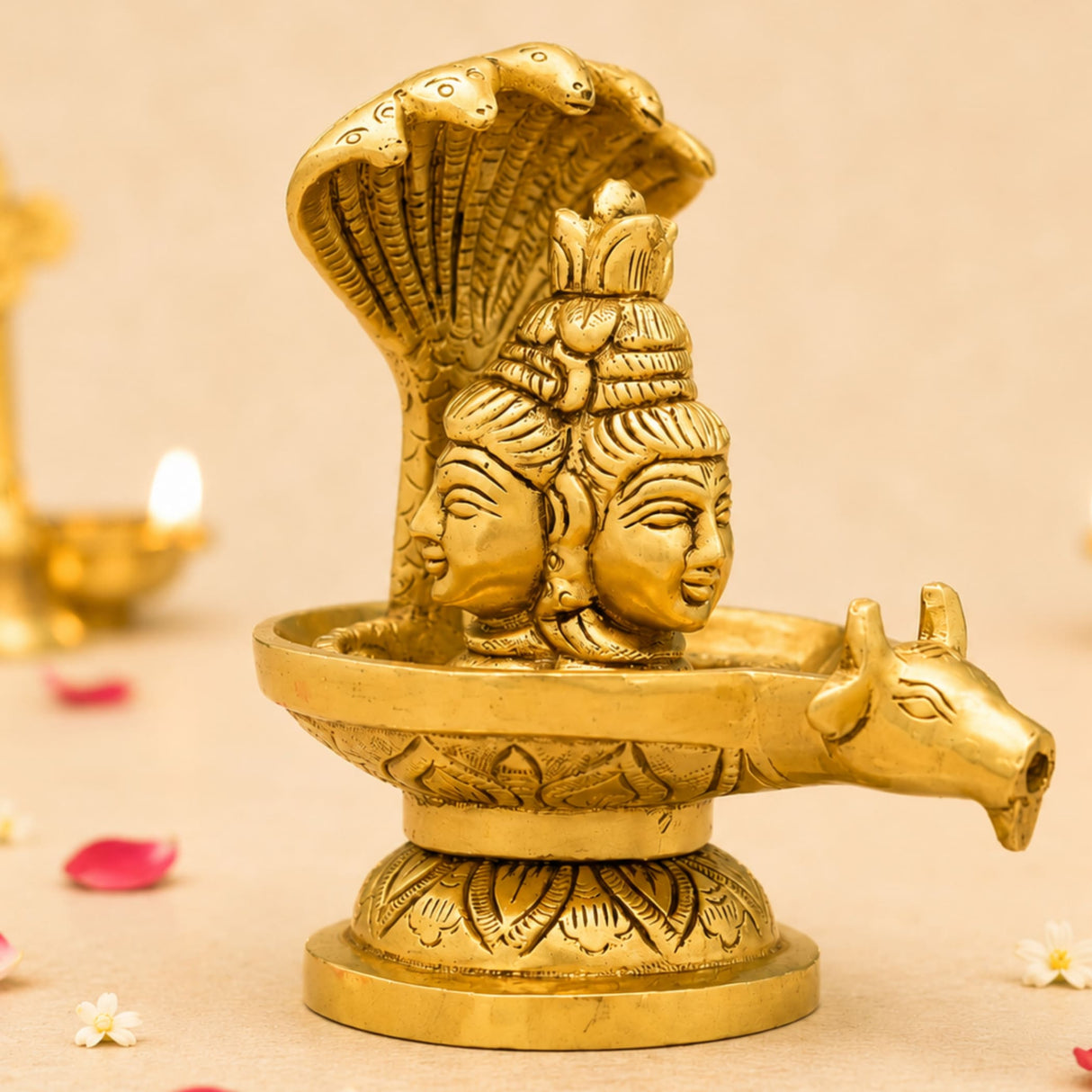 Golden brass shiva lingam statue with intricate three faces and coiled sheshnag serpent for hindu pooja decor
