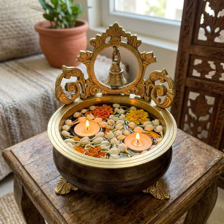7 inch brass urli bowl with bell, ornate floral design, jasmine flowers, candles