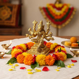 Golden Lakshmi goddess statue with multiple arms in traditional attire for Pooja room