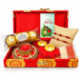 Brocade bhai dooj gift hamper with red and gold ornate box includes designer rakhis chocolates candle holder and ceremonial items