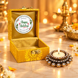 Golden ornate brocade box gift hamper with happy holidays sticker inside lid and tealight candle holders for festive gifts