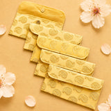 Set of five golden-yellow brocade fabric money envelopes with embroidered paisley pattern and metallic circular clasps