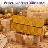 A vibrant yellow brocade fabric money envelope with gold paisley pattern for Indian wedding cash gifts and savings